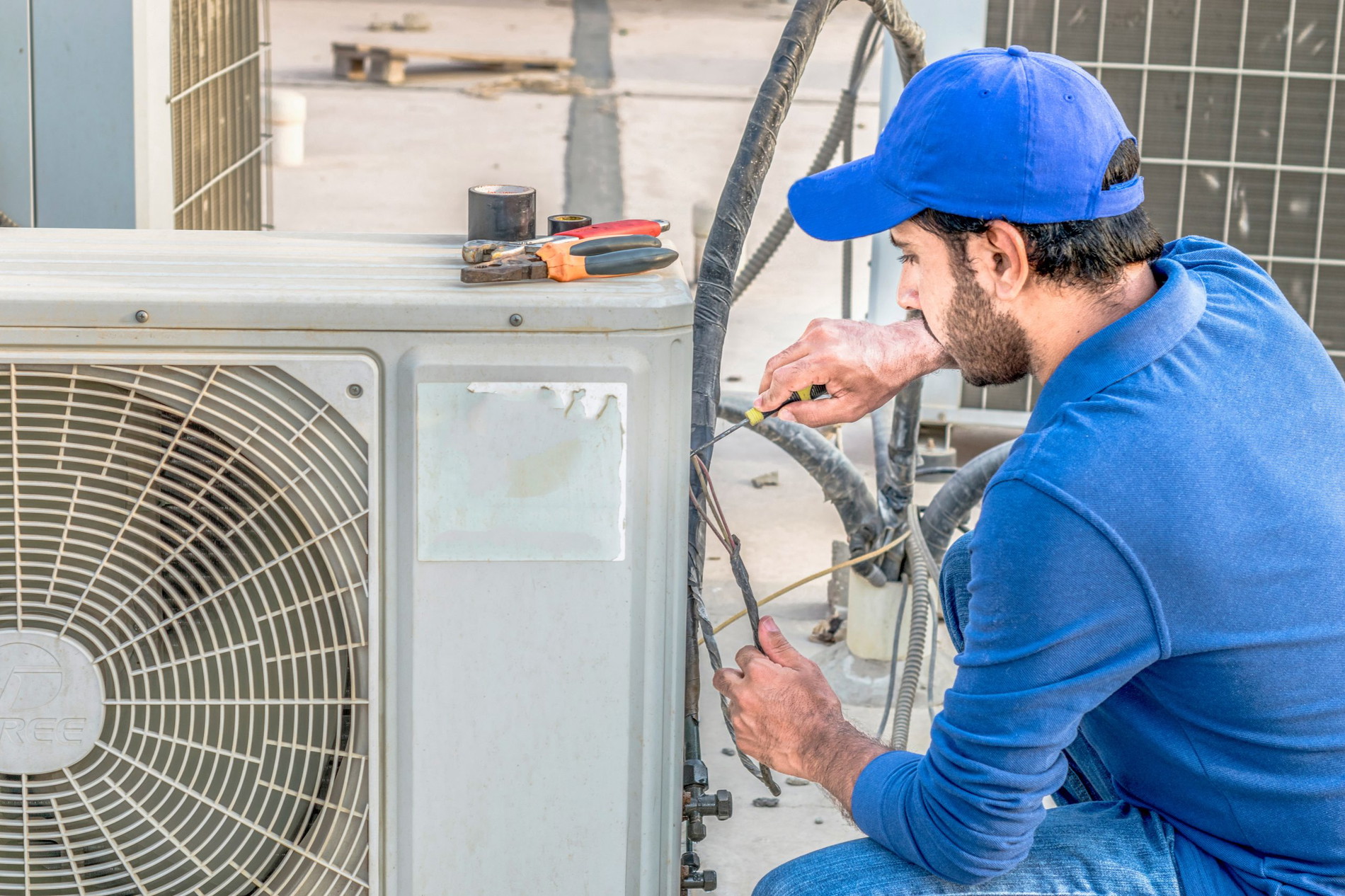 Man working on an air conditioner. 